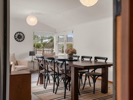 A dining room with a table and chairs at Lake Okareka Holiday Home in Rotorua