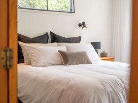 A bedroom with a bed and pillows at Lake Okareka Holiday Home in Rotorua