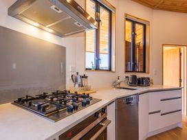 A kitchen with a gas stove and kitchen sink at Ohakune Holiday Home, Ohakune