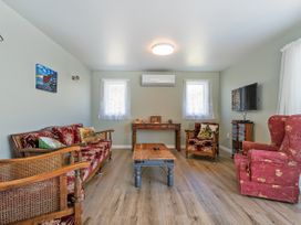 A living room with seating and a television at Whangamata in Whangamata