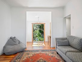 A living room with a sofa and bean bag at Ocean Breeze Cottage - Paekakariki Holiday Home
