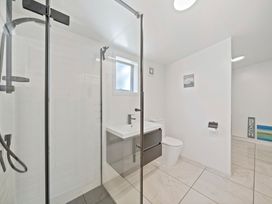 A bathroom with a shower, toilet, and sink at Ocean Breeze Cottage - Paekakariki Holiday Home