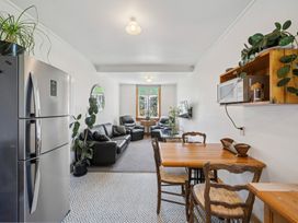 A kitchen with a dining table and chairs at Bellbird House - Paekakariki Holiday Home Paekakariki