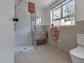 A bathroom with shower, sink, and toilet at Whangarei
