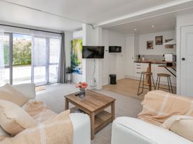 A living room with a coffee table and television at Whangarei
