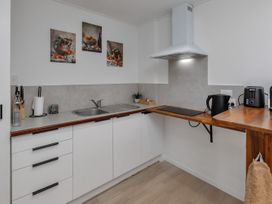 A kitchen with a sink and cooking appliances at Whangarei