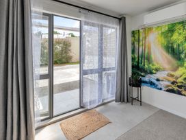 An entryway with a door and wall art at Whangarei