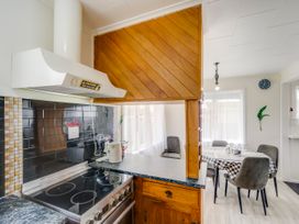 A kitchen with a stove and kettle at Napier