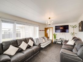 A living room with sofas and a television at Napier in Napier