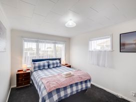 A bedroom with a bed and nightstands at Napier