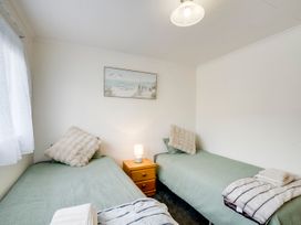 A bedroom with two beds and a painting at Napier in Napier