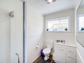 A bathroom with a shower, toilet, and sink at Napier, Napier