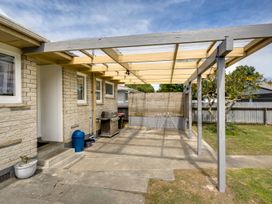 An outdoor patio with a grill and clothes drying rack at Napier in Napier