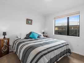 A bedroom with a bed and speakers at Home Away From Home - Ruakaka