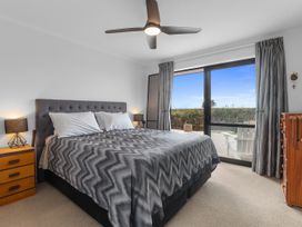 A bedroom with a bed and window at Home Away From Home - Ruakaka