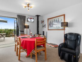 A dining room with a table and chairs at Home Away From Home - Ruakaka