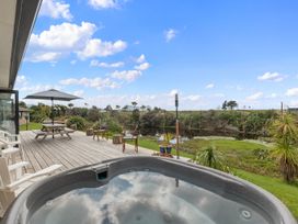 An outdoor space with a hot tub and seating area at Home Away From Home - Ruakaka