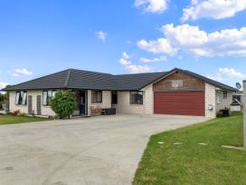 A house with a garage and driveway at Home Away From Home - Ruakaka