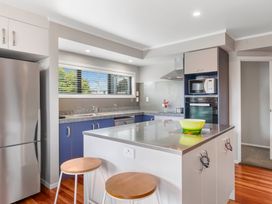 A kitchen with a refrigerator, oven and countertop at Lake Taupo Holiday Home in Lake Taupo