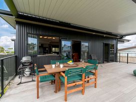 An outdoor seating area with a table and chairs at Lake Taupo Holiday Home, Lake Taupo