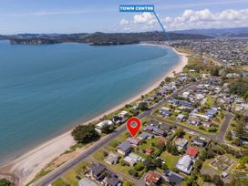 An aerial view of a coastal area with houses and beach near the town centre at Whitianga Holiday Home in Whitianga