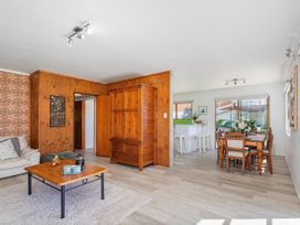 A living room with a coffee table and wooden furniture at Whitianga Holiday Home in Whitianga