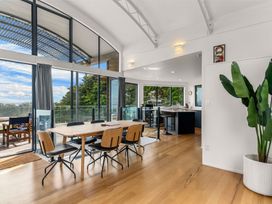 A dining area with a table and chairs at Langscape - Langs Beach Holiday Home Langs Beach