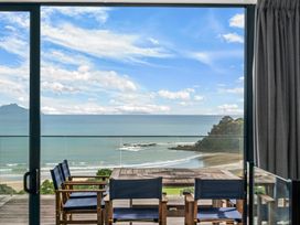 A table and chairs overlooking the ocean at Langscape - Langs Beach Holiday Home Langs Beach