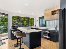 A kitchen with a sink and island at Langscape - Langs Beach Holiday Home Langs Beach