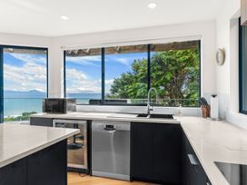 A kitchen with a sink and dishwasher at Langscape - Langs Beach Holiday Home Langs Beach