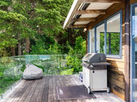 An outdoor area with a grill and bean bag at Langscape - Langs Beach Holiday Home