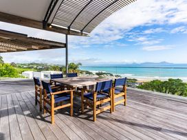 An outdoor patio with a dining table and chairs at Langscape - Langs Beach Holiday Home Langs Beach