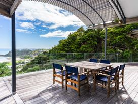 An outdoor deck with a table and chairs at Langscape - Langs Beach Holiday Home Langs Beach