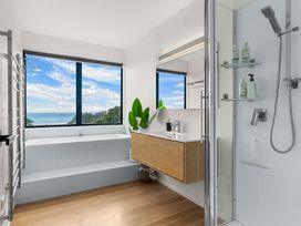 A bathroom with a bathtub and shower at Langscape - Langs Beach Holiday Home Langs Beach