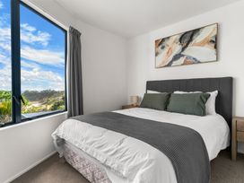 A bedroom with a bed and large window at Langscape - Langs Beach Holiday Home Langs Beach