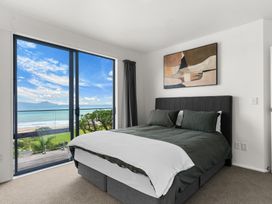 A bedroom with a bed and window view at Langscape - Langs Beach Holiday Home Langs Beach