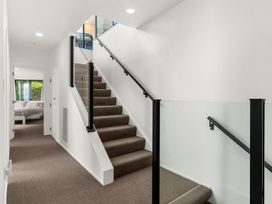 A hallway with stairs and door at Langscape - Langs Beach Holiday Home in Langs Beach