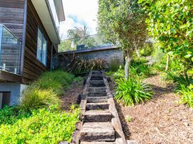 A pathway with wooden stairs and greenery at Langscape - Langs Beach Holiday Home in Langs Beach
