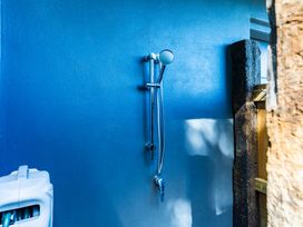 A shower setup on a blue wall at Langscape - Langs Beach Holiday Home Langs Beach