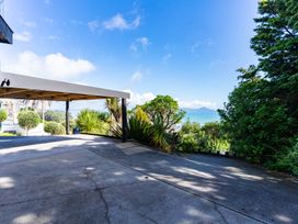 A carport with a driveway and plants at Langscape - Langs Beach Holiday Home Langs Beach