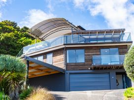 A house with a balcony and garage at Langscape - Langs Beach Holiday Home Langs Beach