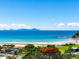 A beach with ocean and islands at Langscape - Langs Beach
