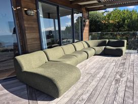 An outdoor space with a sectional sofa at Langscape - Langs Beach Holiday Home, Langs Beach