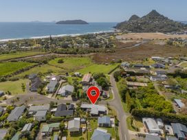 An aerial view of houses near the beach at Tairua Holiday Home in Tairua
