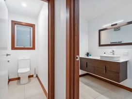 A bathroom with toilet and sink at Tairua Holiday Home in Tairua