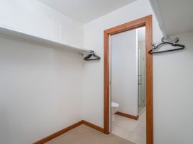 A bathroom with a toilet and a shower at Tairua Holiday Home in Tairua