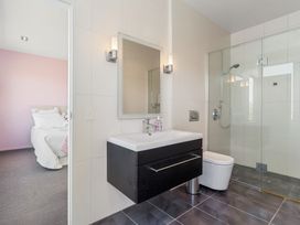 A bathroom with a sink and shower at Auckland Holiday Home in Auckland