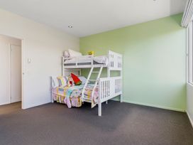 A bedroom with a bunk bed and stuffed animal at Auckland Holiday Home in Auckland