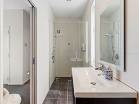 A bathroom with a shower and sink at Auckland Holiday Home Auckland