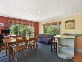 A living room with a dining table and a sofa at Picton